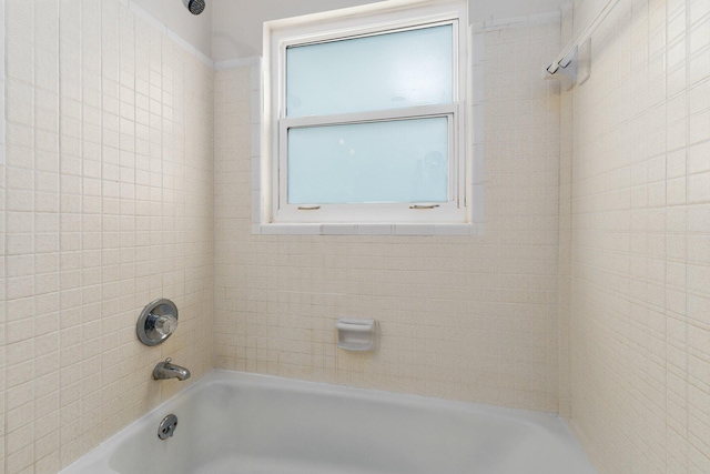 bathroom with tiled shower / bath and plenty of natural light