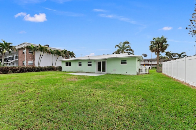 back of property featuring a yard and a patio area