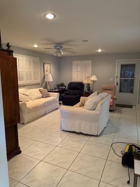 tiled living room featuring ceiling fan