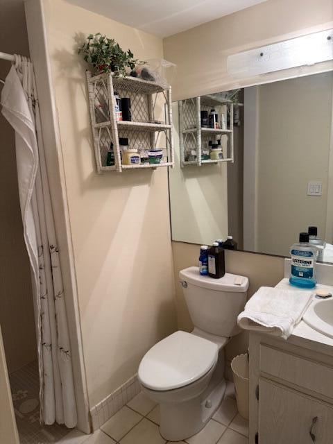 bathroom featuring tile patterned floors, vanity, and toilet