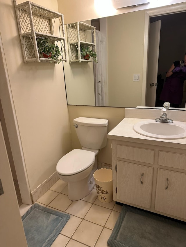bathroom with tile patterned floors, toilet, and vanity