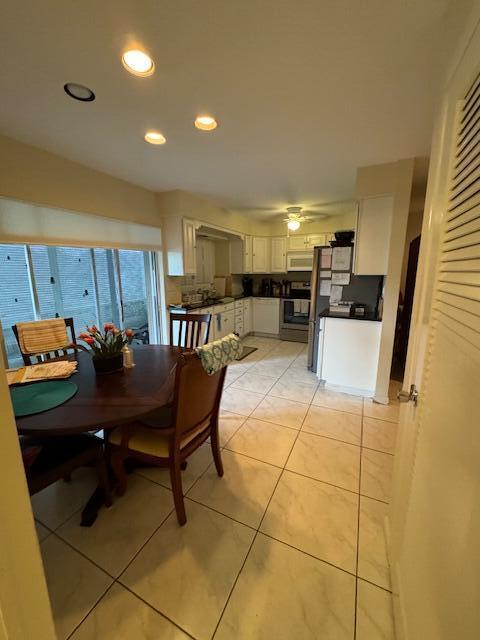 tiled dining area featuring ceiling fan