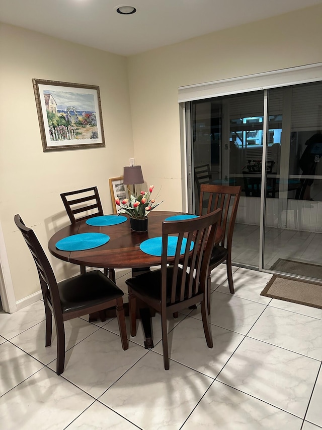 dining space featuring light tile patterned floors