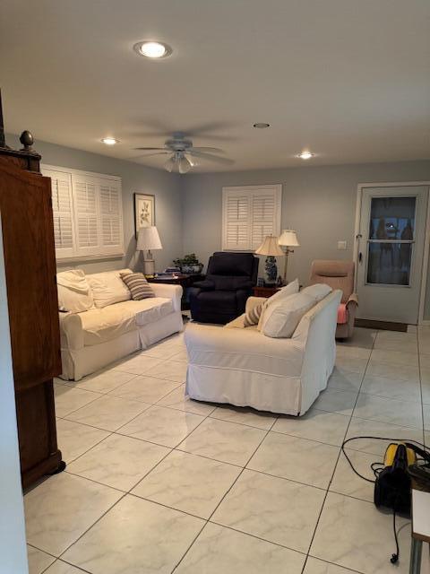 living area with a ceiling fan, recessed lighting, and light tile patterned floors