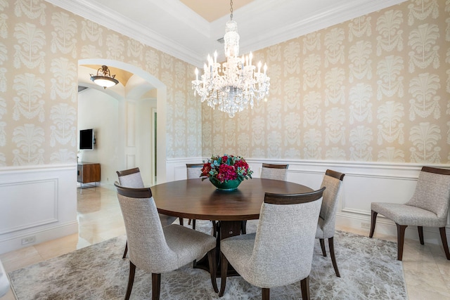 tiled dining room with crown molding and a chandelier