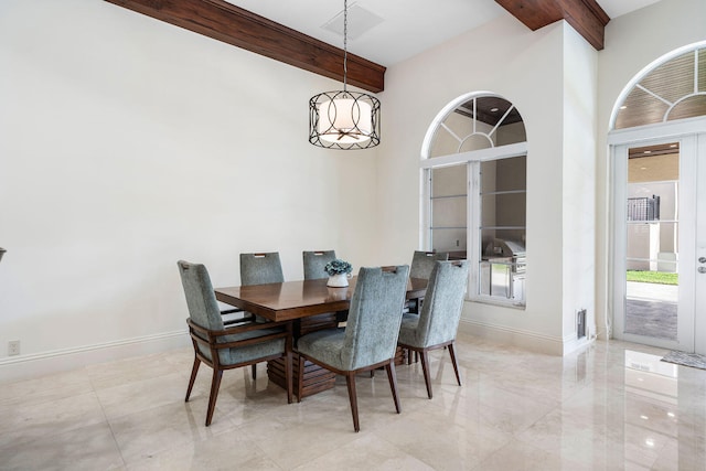 dining space featuring beam ceiling and an inviting chandelier