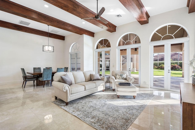 living room with french doors, beamed ceiling, a high ceiling, and ceiling fan with notable chandelier