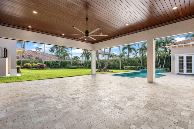 view of swimming pool featuring a lawn, a patio area, and ceiling fan