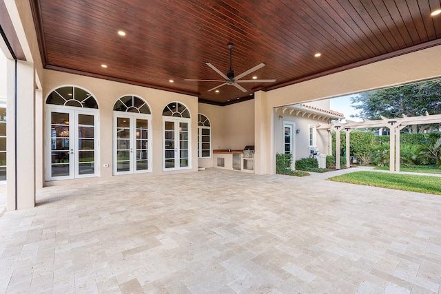 view of patio / terrace featuring grilling area, french doors, a pergola, ceiling fan, and exterior kitchen