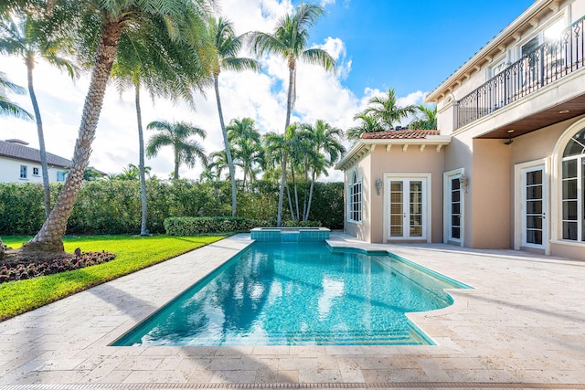 view of swimming pool with an in ground hot tub, french doors, and a patio