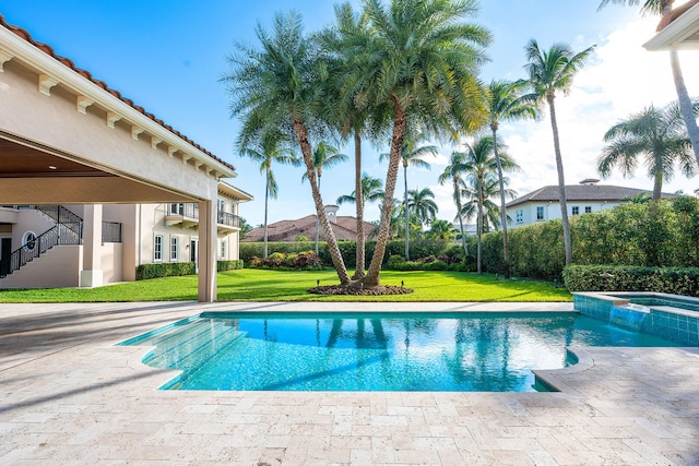 view of pool featuring a lawn, a mountain view, and an in ground hot tub