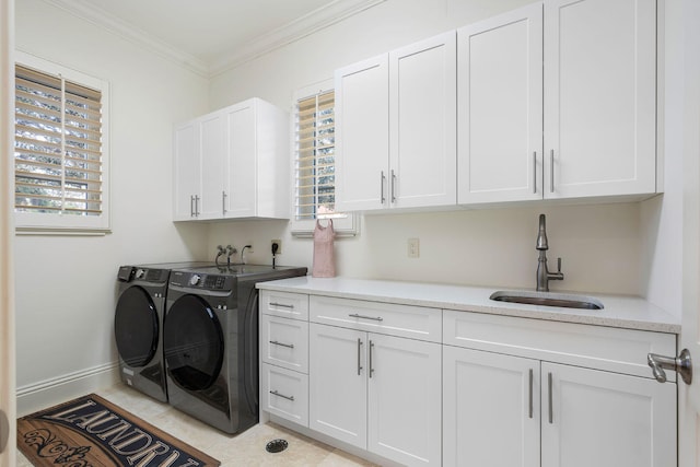 clothes washing area with cabinets, crown molding, sink, light tile patterned flooring, and washing machine and clothes dryer