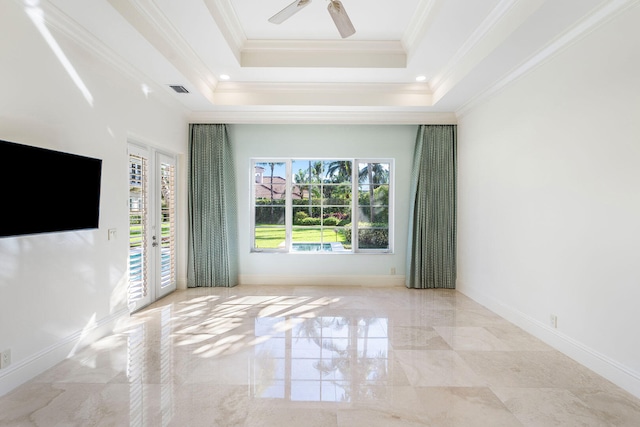 unfurnished living room with ceiling fan, a raised ceiling, crown molding, and french doors