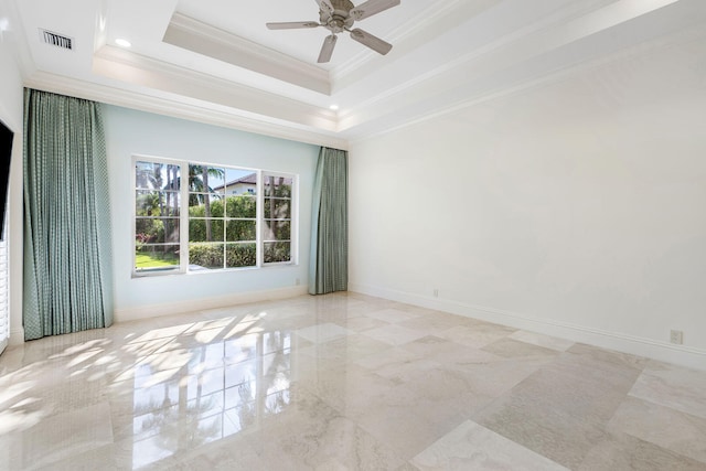 empty room featuring a raised ceiling, ceiling fan, and crown molding