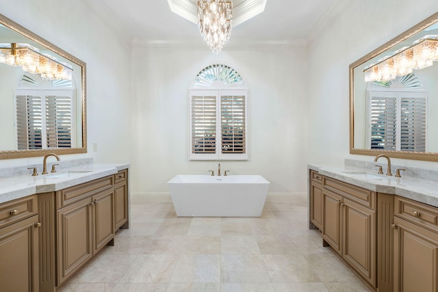 bathroom with vanity, a bath, a notable chandelier, and ornamental molding