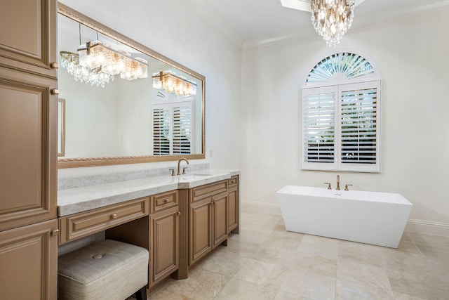 bathroom featuring a bathing tub, a notable chandelier, crown molding, and vanity