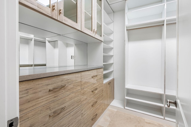 spacious closet featuring light tile patterned floors