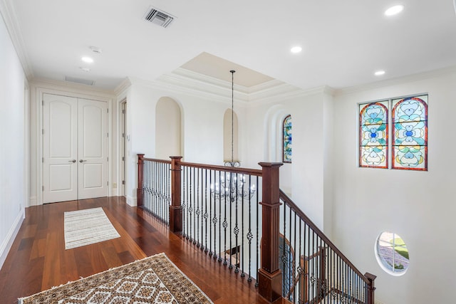 hallway featuring dark hardwood / wood-style flooring and crown molding