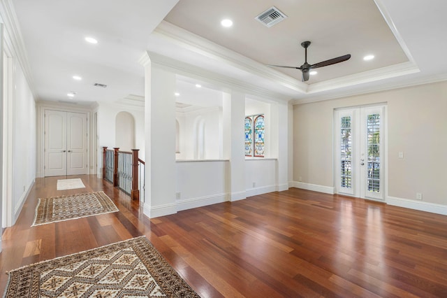 spare room featuring ornamental molding, a raised ceiling, and dark wood-type flooring