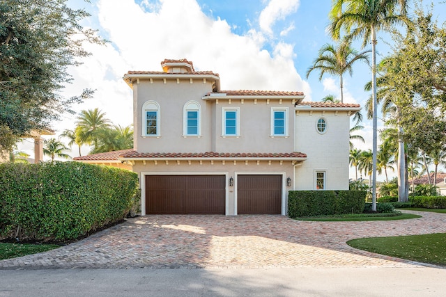 mediterranean / spanish home featuring a garage