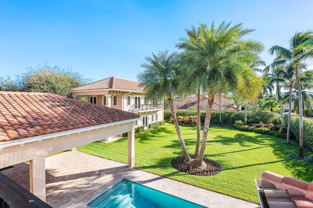 view of swimming pool with a patio area and a yard