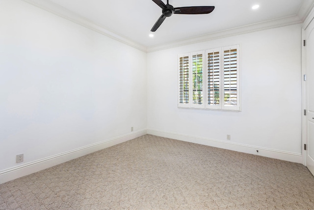 carpeted empty room with ceiling fan and ornamental molding