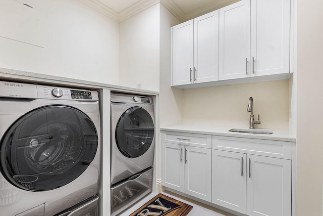 laundry room with cabinets, sink, ornamental molding, and independent washer and dryer