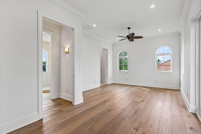 unfurnished room featuring ceiling fan, light wood-type flooring, and crown molding