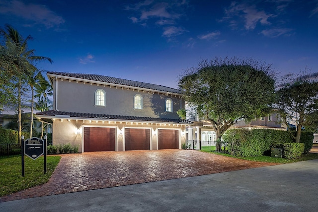 view of front of property with a garage and a yard