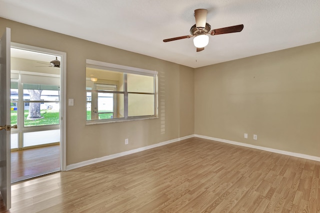 empty room featuring light hardwood / wood-style flooring, a textured ceiling, and ceiling fan