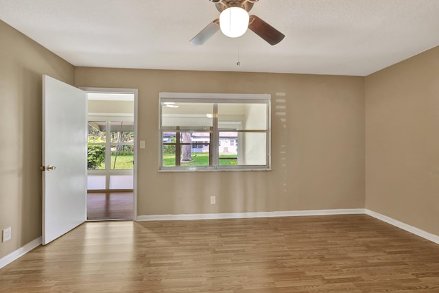 515 High Point Dr Unit B, Delray Beach, FL 33445 - spare room featuring wood finished floors, baseboards, and ceiling fan