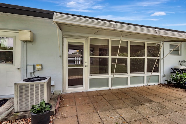 entrance to property featuring a patio and central AC