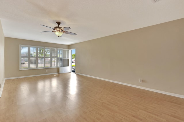 spare room featuring ceiling fan, a textured ceiling, and light wood-type flooring