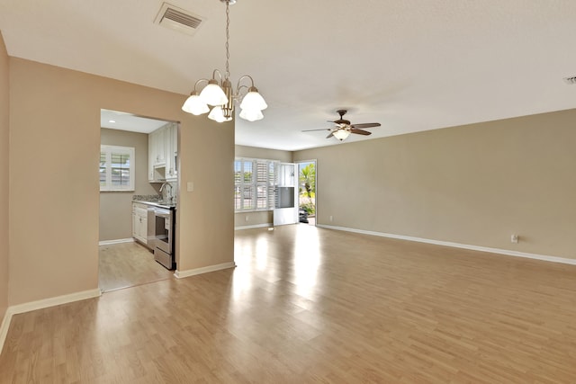 interior space featuring sink, ceiling fan with notable chandelier, and light wood-type flooring