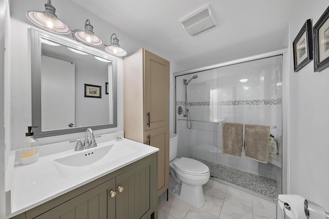 bathroom featuring tile patterned flooring, vanity, toilet, and a shower with shower door