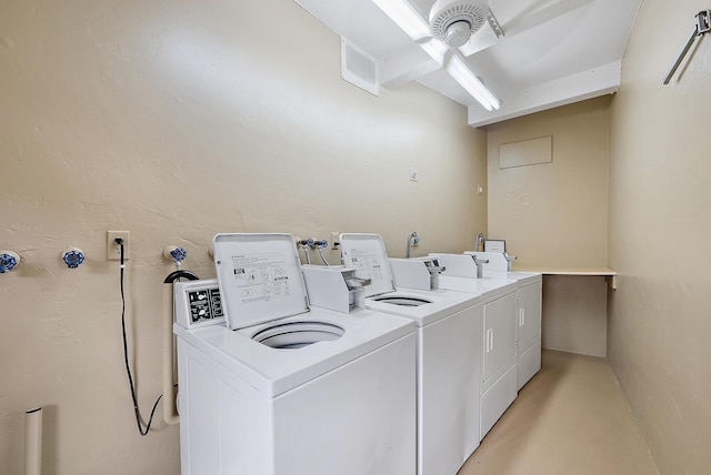 laundry room with separate washer and dryer