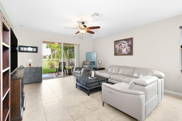 living room featuring light tile patterned floors and ceiling fan