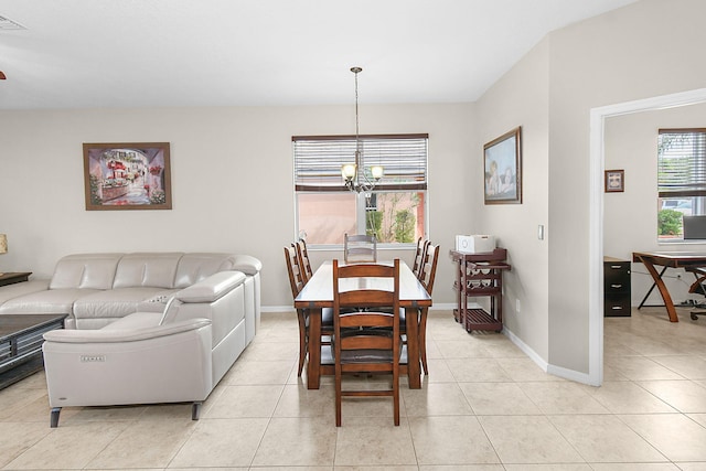 dining area with a notable chandelier and light tile patterned floors