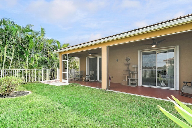 back of house featuring a yard, ceiling fan, and a patio