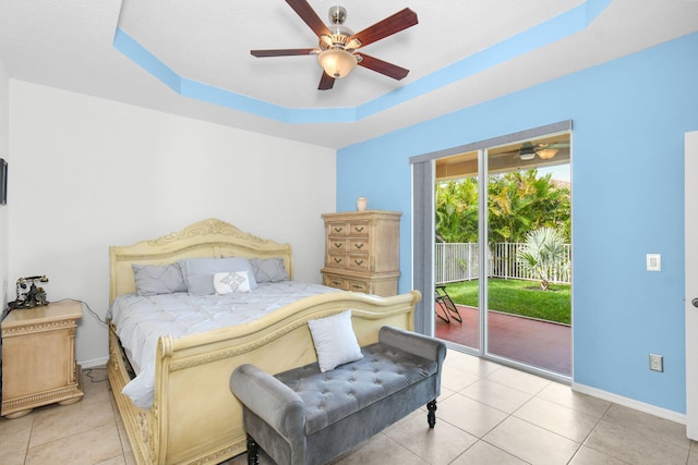 tiled bedroom featuring a raised ceiling, access to outside, and ceiling fan