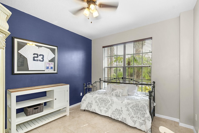 tiled bedroom featuring ceiling fan