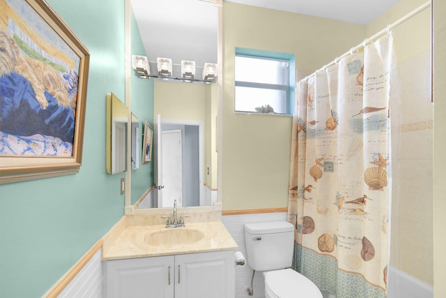 bathroom with tile walls, vanity, and toilet