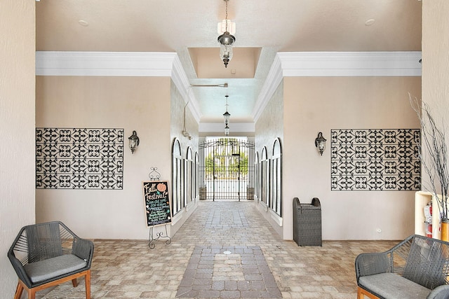 entrance foyer with a notable chandelier and ornamental molding