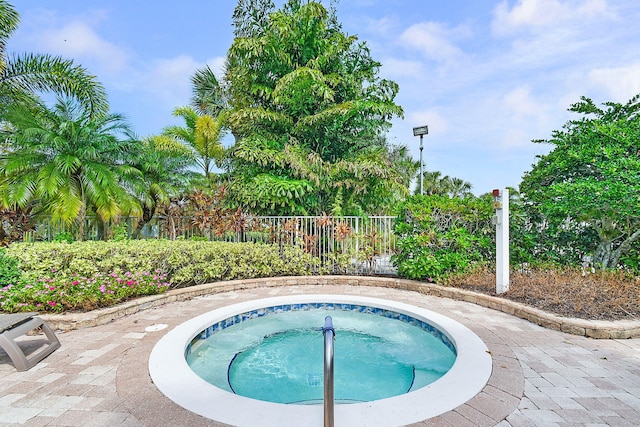 view of swimming pool featuring an in ground hot tub