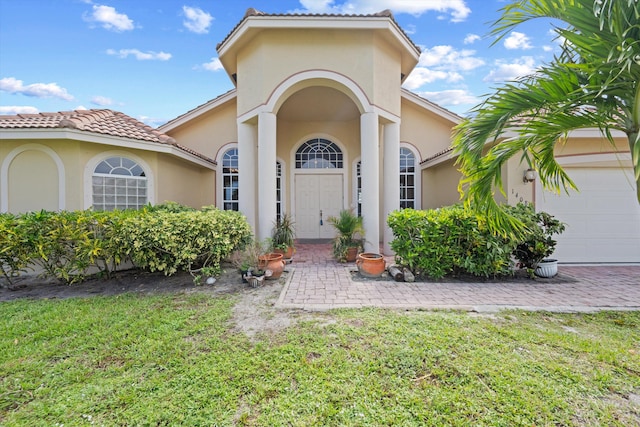 entrance to property with a yard and a garage