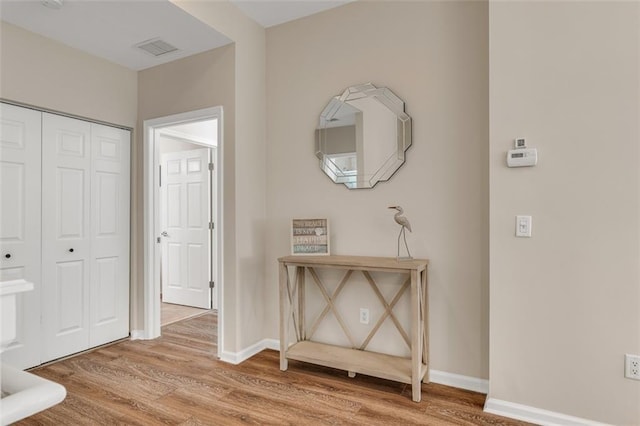 hall with hardwood / wood-style floors