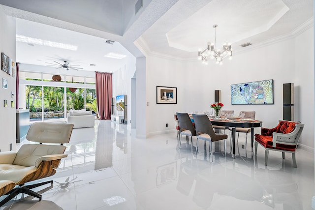 dining room featuring crown molding, a raised ceiling, and ceiling fan with notable chandelier