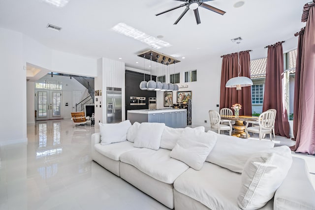 living room with french doors and ceiling fan