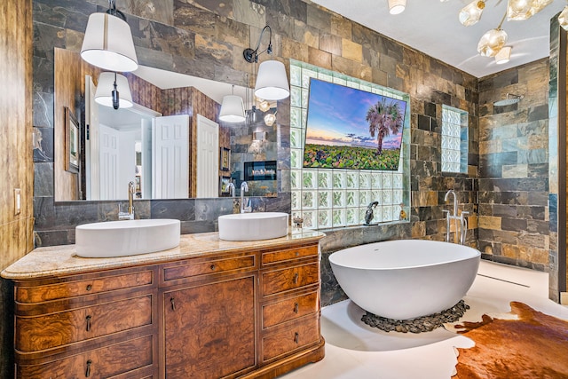 bathroom featuring vanity, tile walls, and shower with separate bathtub