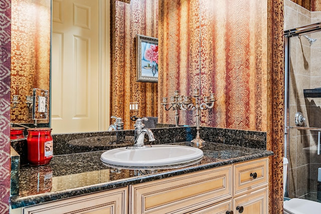 bathroom with vanity, toilet, and an enclosed shower